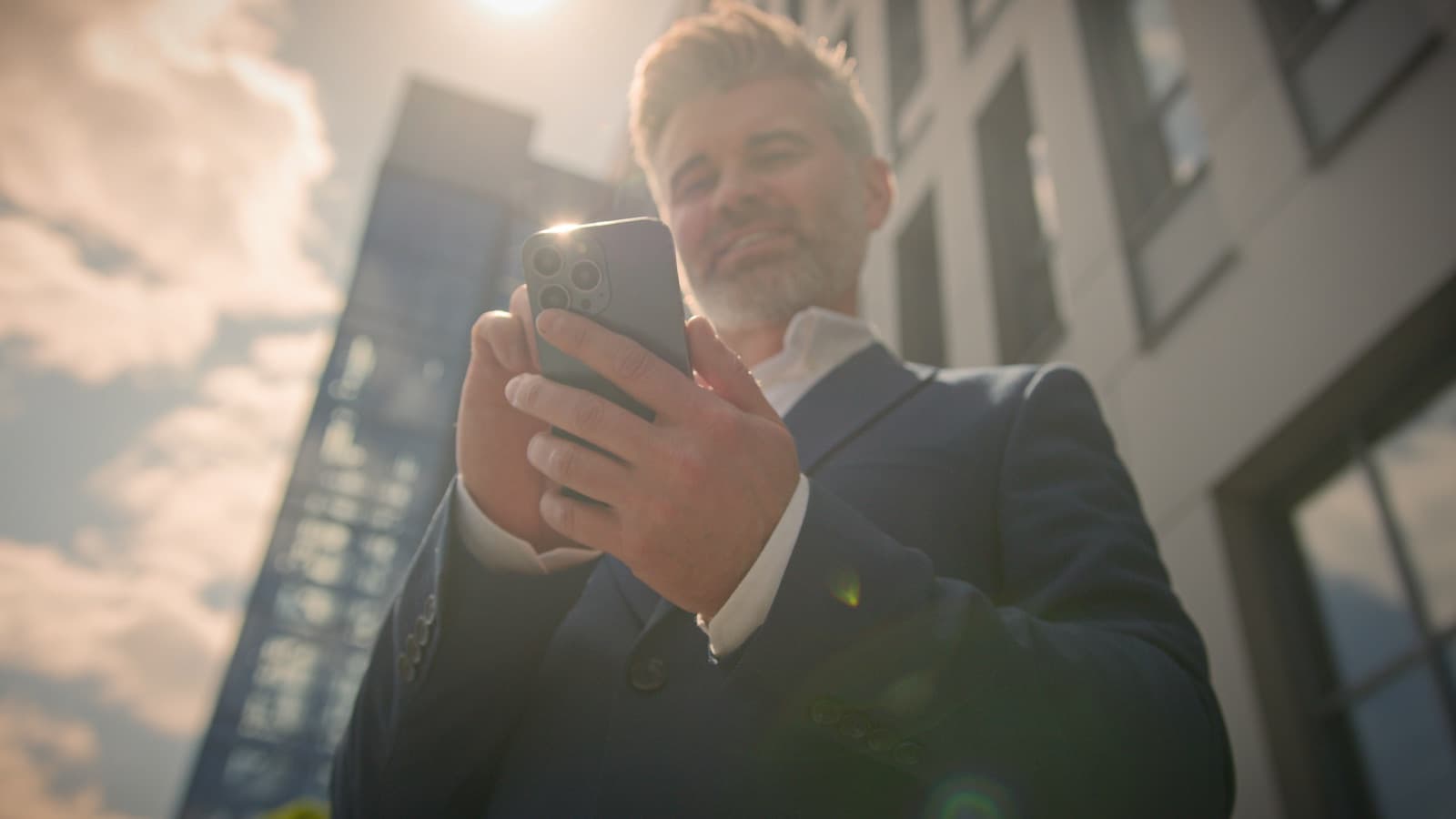 Senior professional using a mobile phone while reviewing 401(k) employer match benefits.