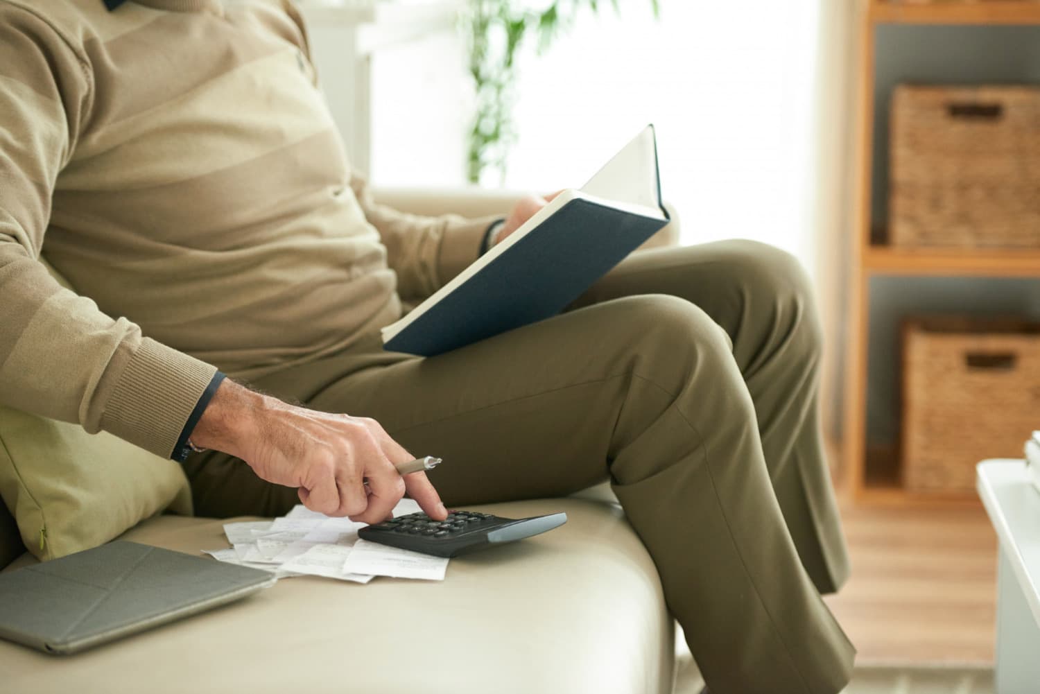 A person reviewing retirement paperwork and calculating Roth IRA contribution planning.