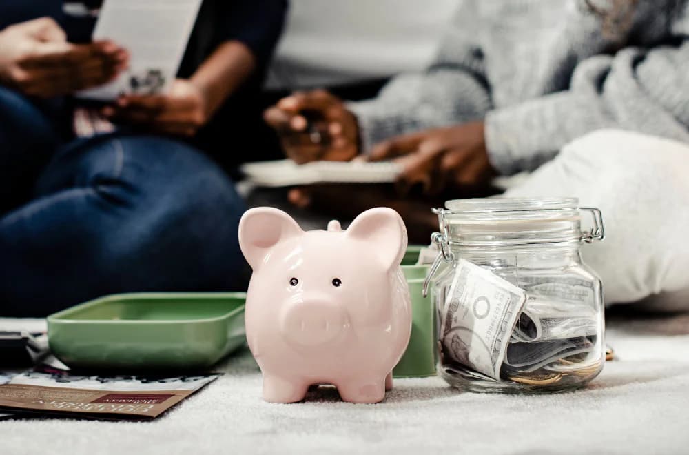 Piggy bank and savings jar representing 401(k) employer matching contributions.