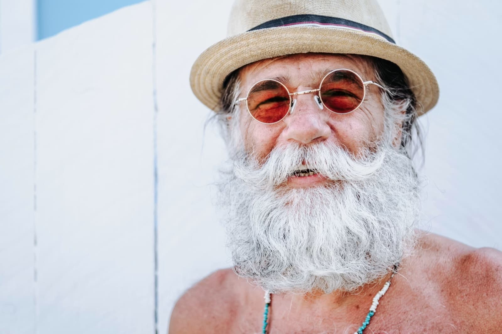 Smiling older man in sunglasses representing an active early retirement lifestyle.