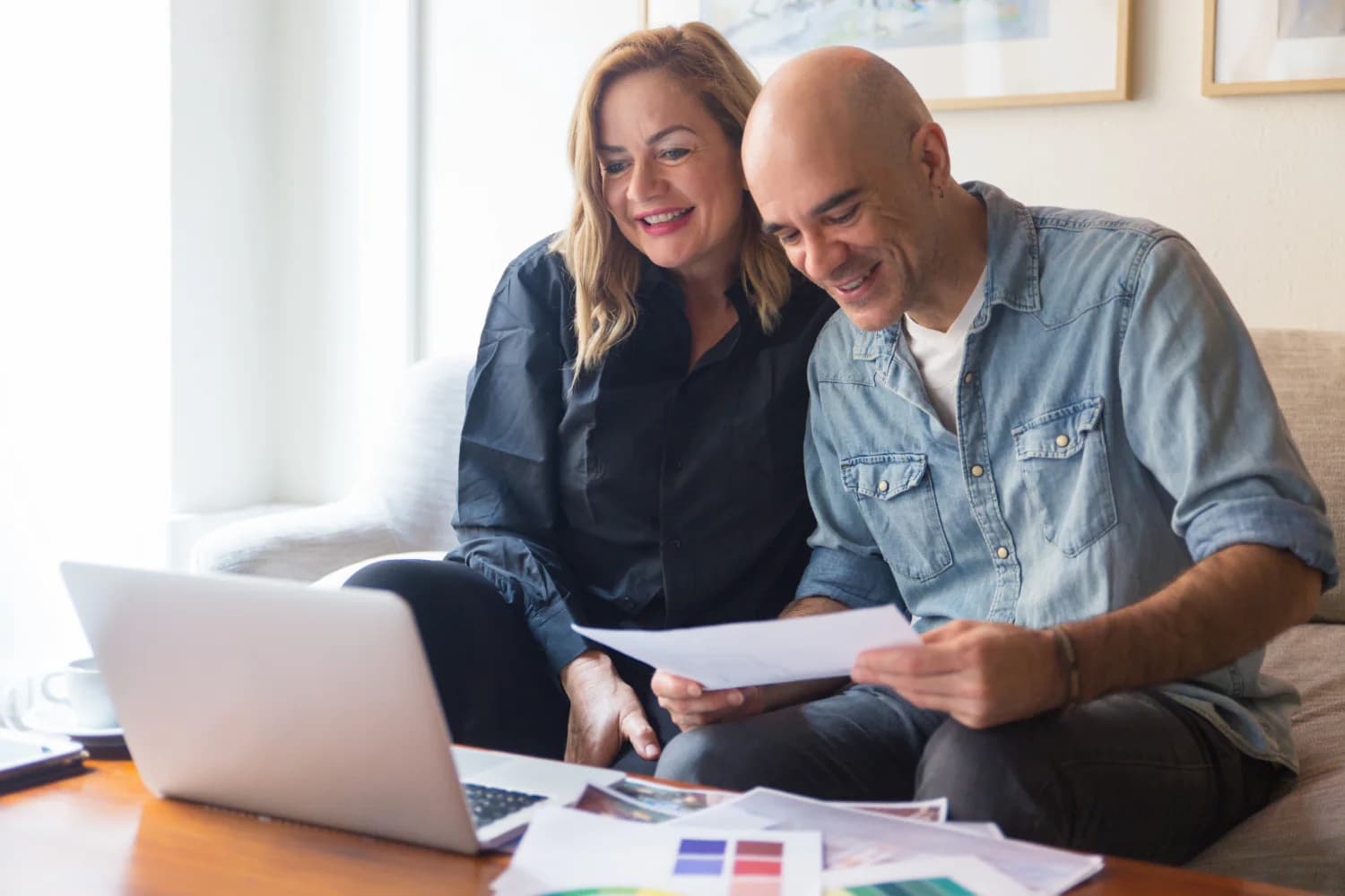 Couple reviewing retirement account paperwork and required minimum distribution planning at home.