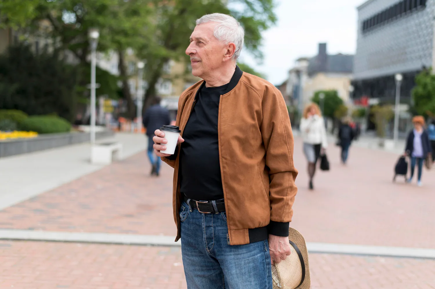Older man walking with coffee while considering work and Social Security survivor benefits.