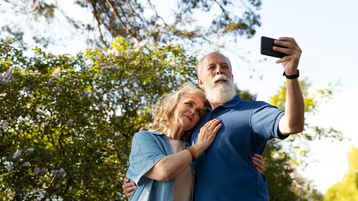 Retired couple reviewing beneficiary planning decisions together outdoors