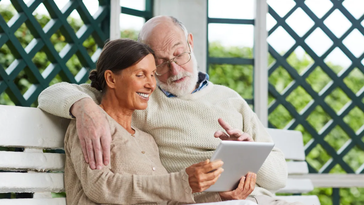 Retired couple reviewing Texas TRS survivor annuity options on a tablet
